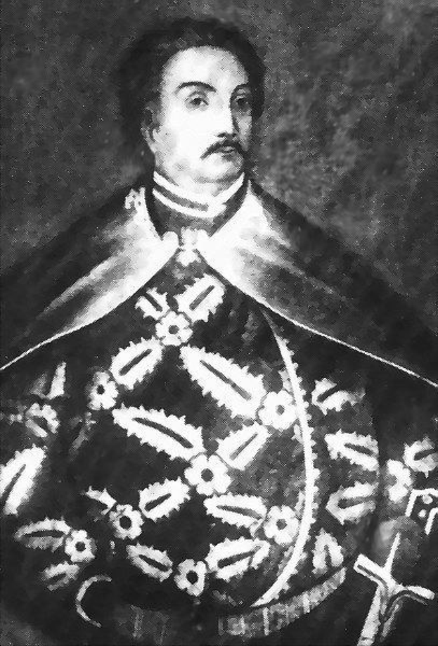 Schwarzes und weißes Foto von Papst Johannes Paul II. in Priesterrobe, der eine schwarze Robe mit weißem Kragen und Manschetten trägt und die Hände verschränkt, mit einem strengen Gesichtsausdruck und direktem Blick.