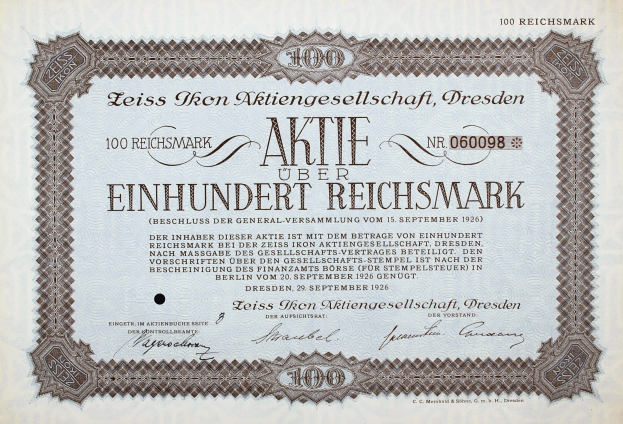 Altes deutsches Wertpapier zu 100 Reichsmark mit schwarzem Rand und gedrucktem Text.